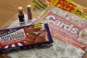 Two nail varnishes, a bar of chocolate and a card-making magazine