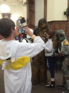 Designer Holly from OUP gets up close and personal with Chewbacca, while Frazer (dressed as a unicorn) takes their photo